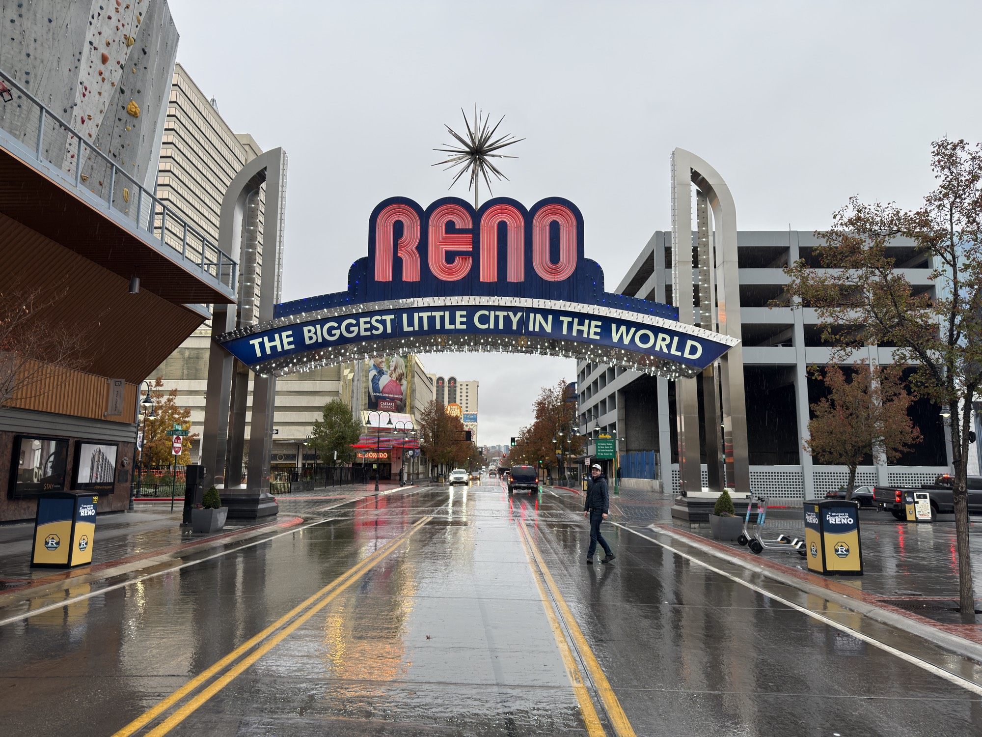 The Reno arch over an empty, rain-wet street